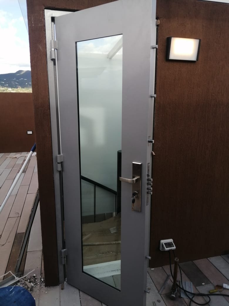 Puerta blindada de seguridad con acabado en madera instalada en Bogotá
